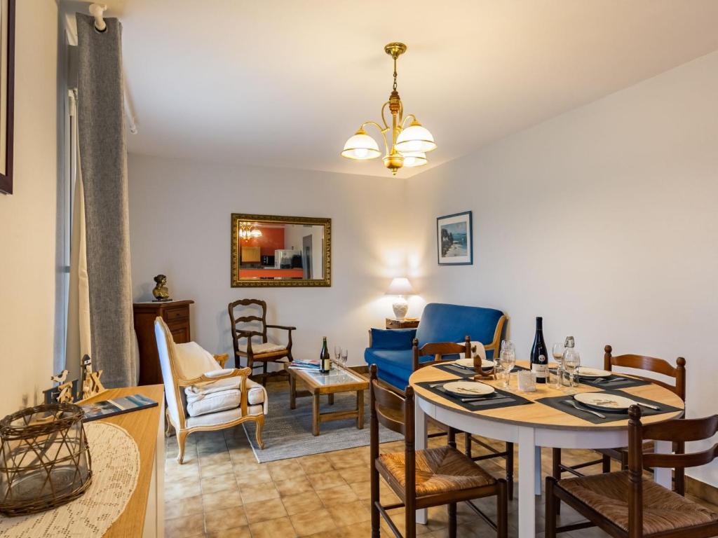 a living room with a dining room table and chairs at Holiday Home Les Dunes by Interhome in Saint-Pabu