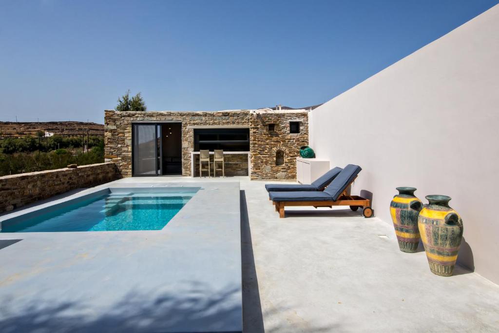 a villa with a swimming pool and a patio at VF Villa Agios Fokas Tinos in Tinos