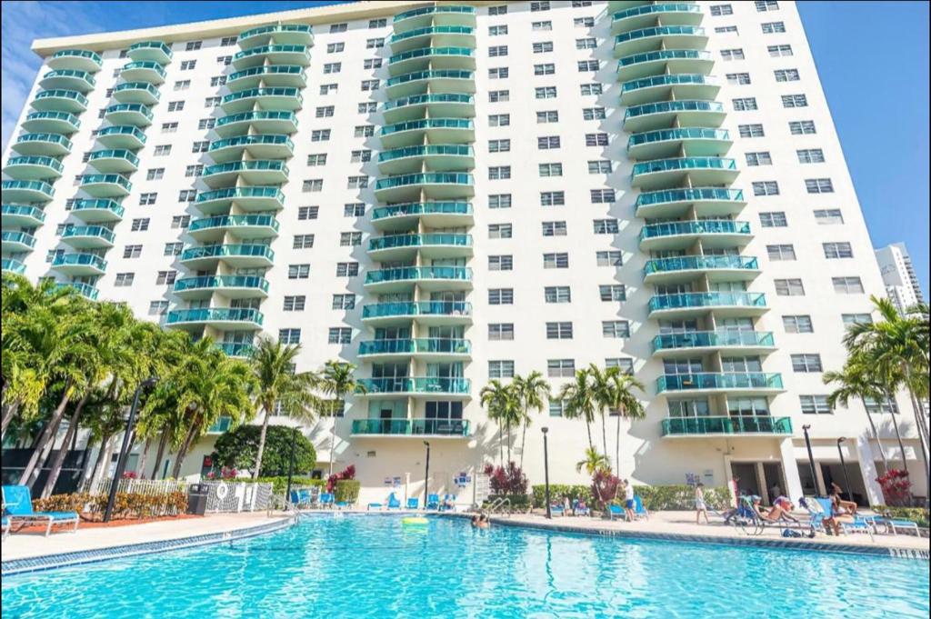 a swimming pool in front of a large building at Apartment Vacation Sunny Isles Beach in Sunny Isles Beach