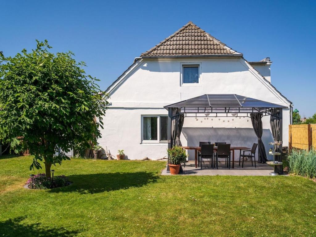 a white house with a gazebo in the yard at Tranquil Pepelow Retreat in Pepelow