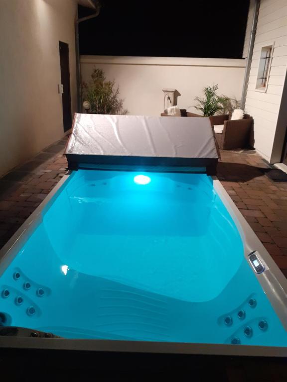 a swimming pool in a backyard with blue water at Chez Angel in Varennes-sur-Morge