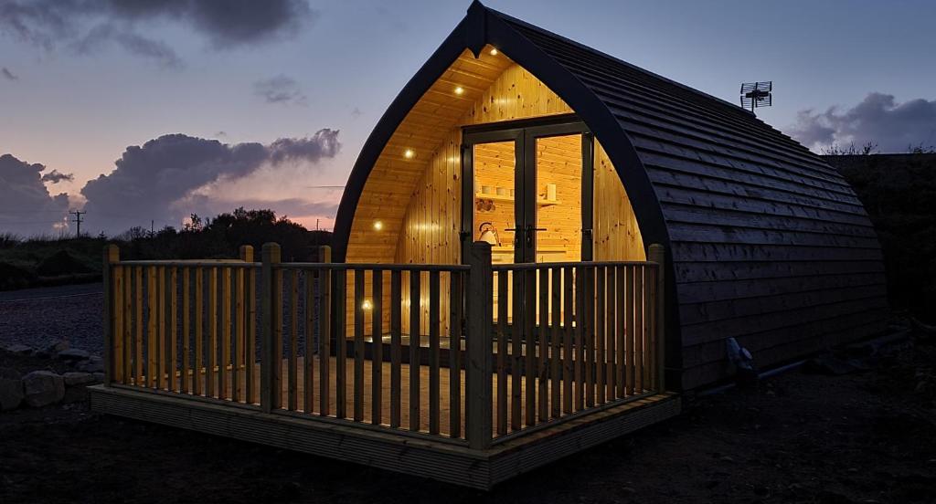 a small wooden cabin with a large window at Loch Ewe Luxury Pods in Mellon Charles