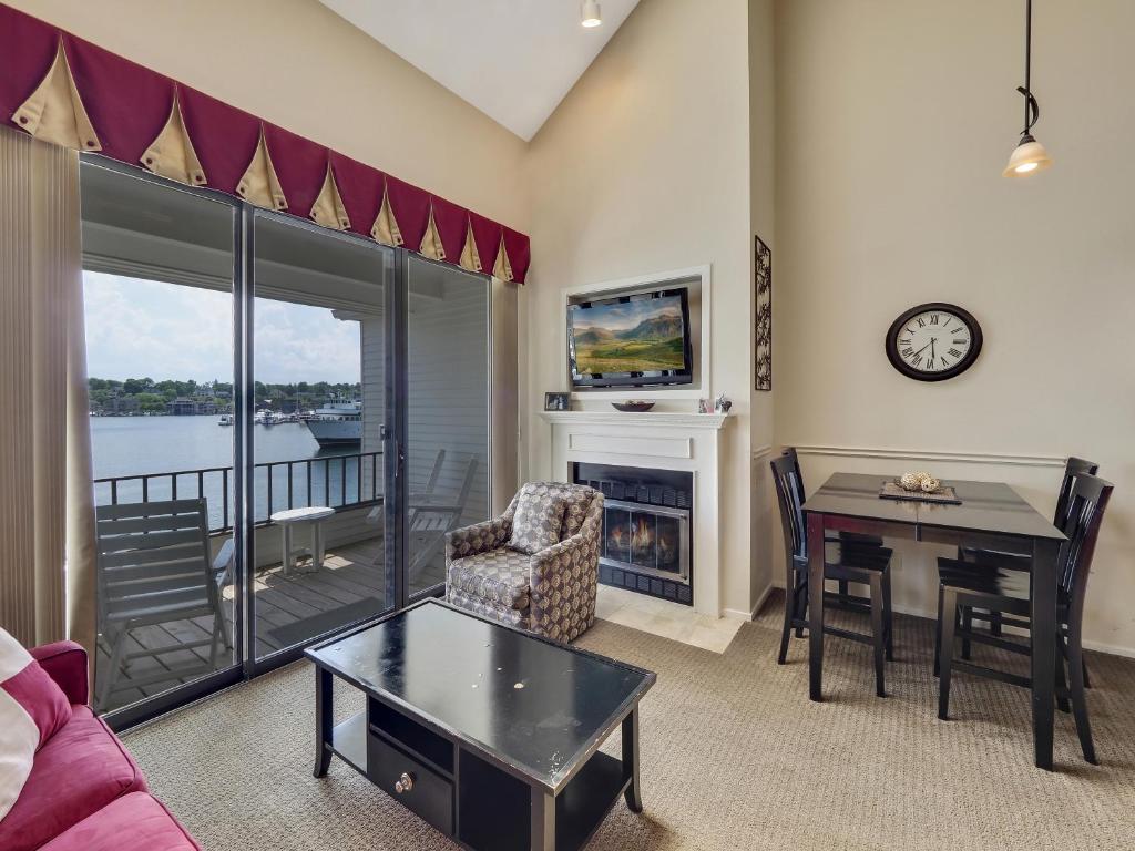 a living room with a table and a fireplace at 343 Edgewater Inn in Charlevoix