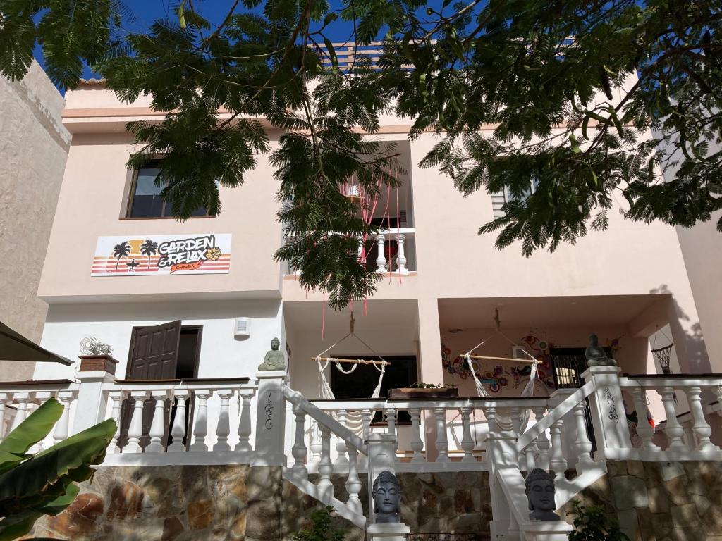 a white house with a white staircase in front of it at Corralejo Garden&Relax in Corralejo