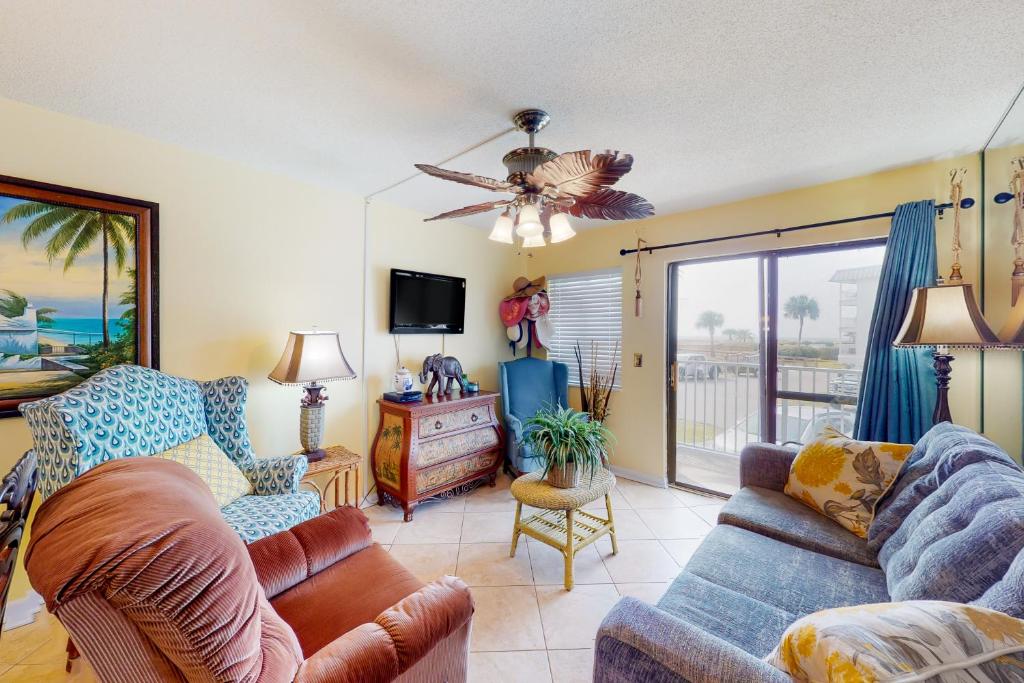 a living room with a couch and a tv at Plantation East #1104 in Gulf Highlands
