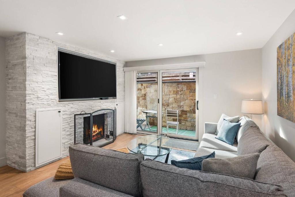 a living room with a couch and a fireplace at 700 Monarch 104 in Aspen