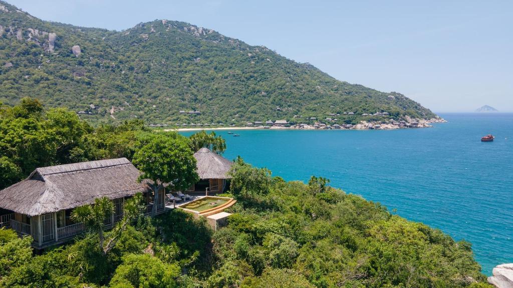 an image of a house on a hill next to the ocean at Six Senses Ninh Van Bay in Ninh Van Bay