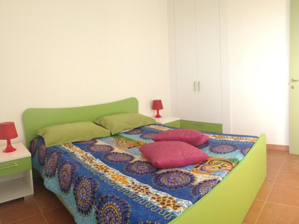 Postel nebo postele na pokoji v ubytování Pitagora Residence