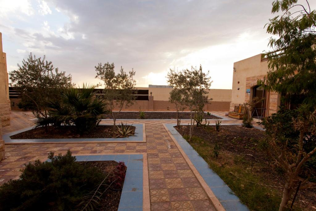 a courtyard in the middle of a building with trees at Arab Divers Dive Center and Bed & Breakfast in Aqaba