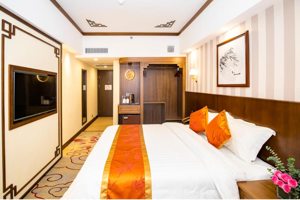 Postel nebo postele na pokoji v ubytování Fu Hua Hotel