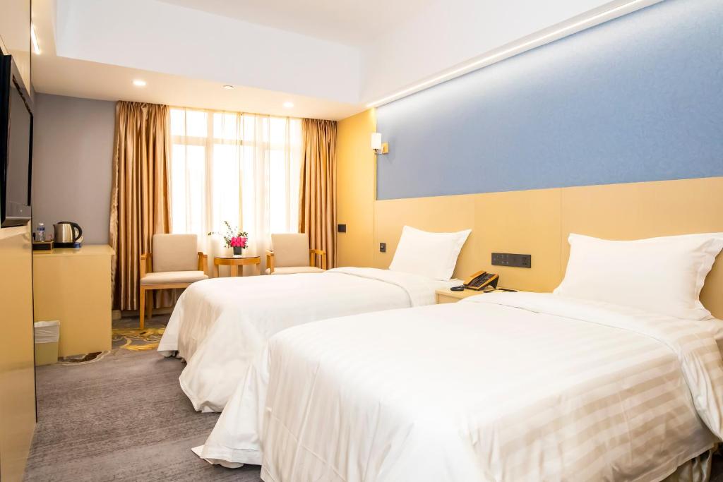 Postel nebo postele na pokoji v ubytování Fu Hua Hotel