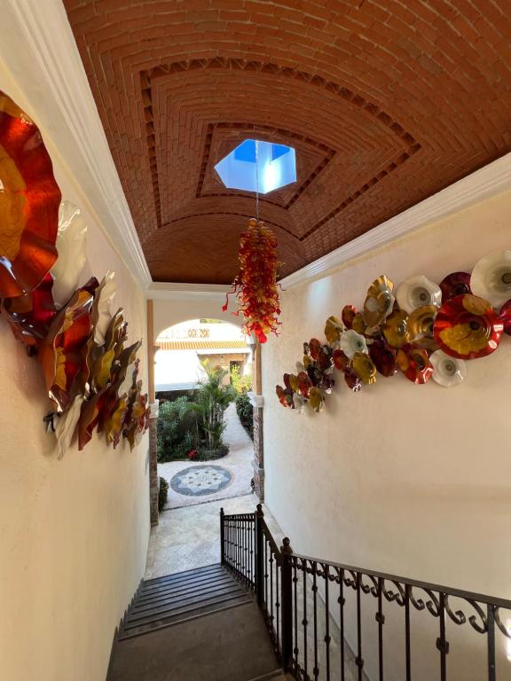 a hallway of a home with flowers on the wall at Mesón de las Delicias in Cuernavaca