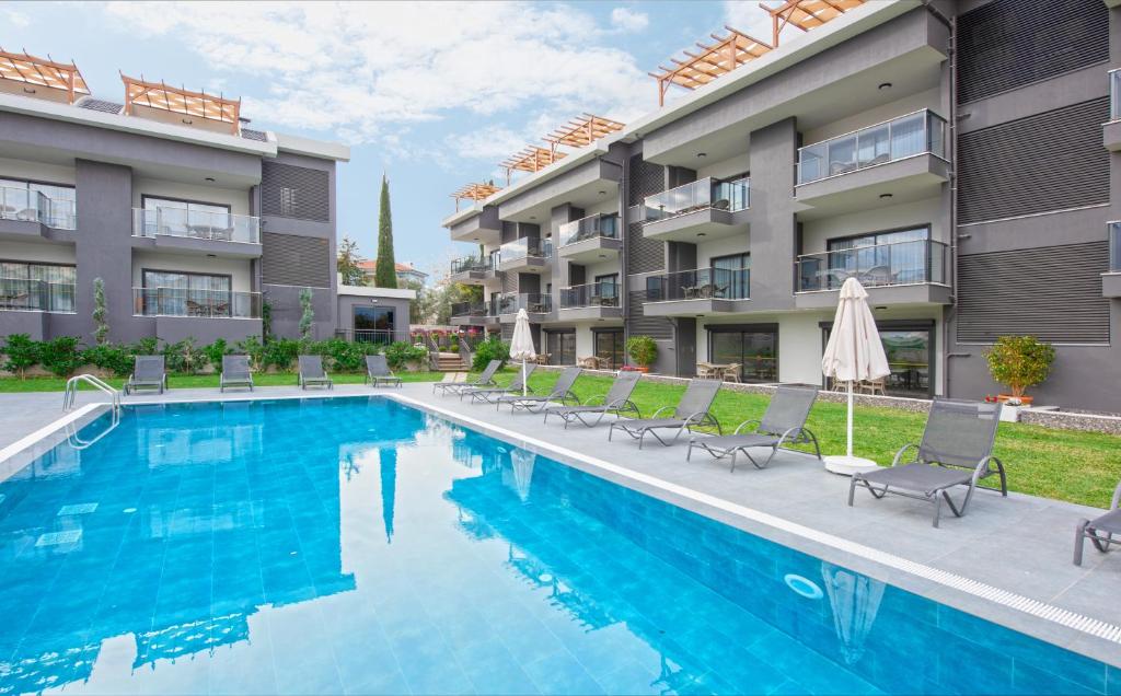 a swimming pool in front of a apartment building at A Suite Side in Side