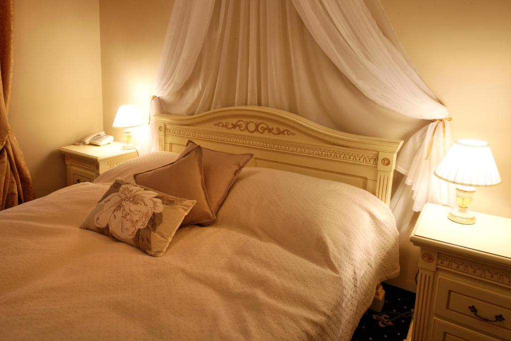 Postel nebo postele na pokoji v ubytování Alisa Hotel