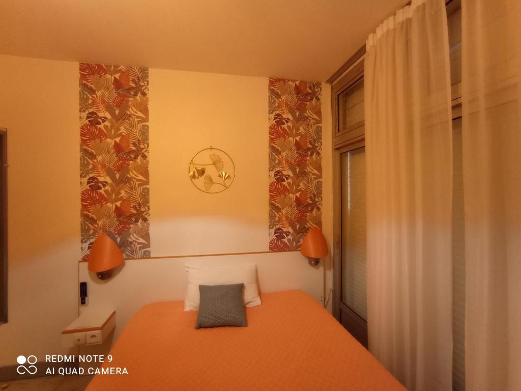 Postel nebo postele na pokoji v ubytování hotel l'échappée d'oléron