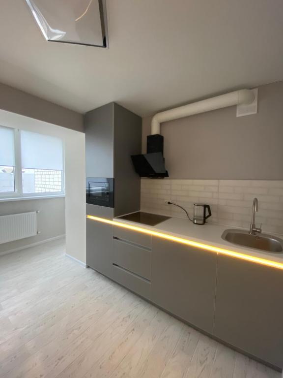 a kitchen with a sink and a counter at Свіжа та стильна квартира! in Cherkasy