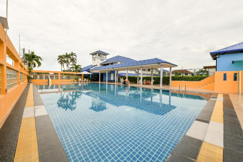 a swimming pool with blue tiles in a building at Pattaya Bed Boutique SHA in Nong Prue