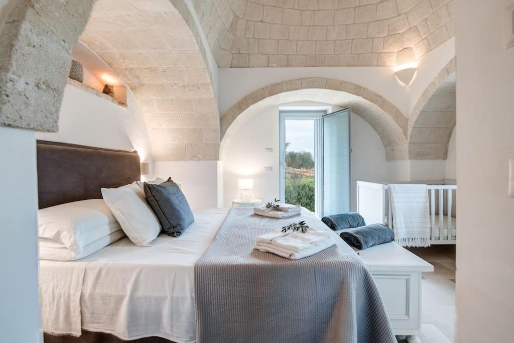 A bed or beds in a room at Trulli Gianpaolo - Luxury Villa