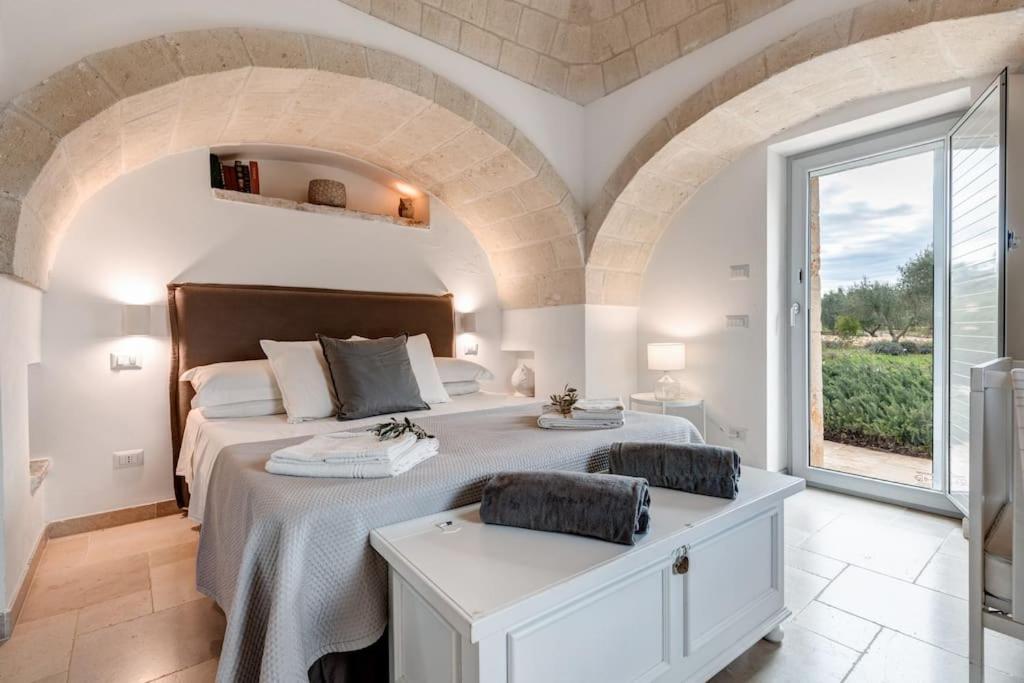 A bed or beds in a room at Trulli Gianpaolo - Luxury Villa