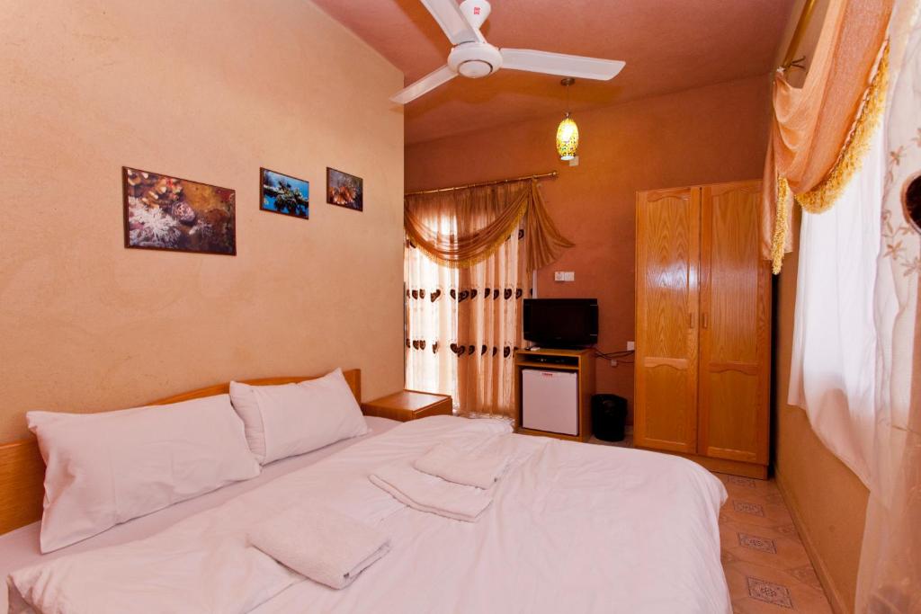 a bedroom with a white bed in a room at Arab Divers Dive Center and Bed & Breakfast in Aqaba
