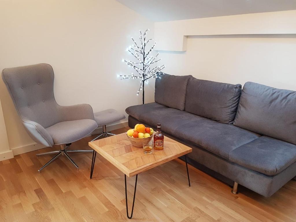 a living room with a couch and a table with a bowl of fruit at Ferienwohnung Rainer in Fieberbrunn