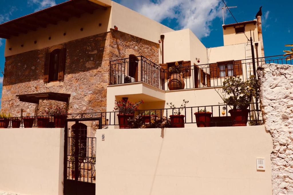 a large white building with balconies on top of it at The Old House Cottage in Malia