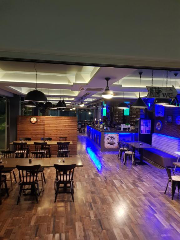 a dining room with tables and chairs and blue lights at Euronapa Hotel Apartments in Ayia Napa