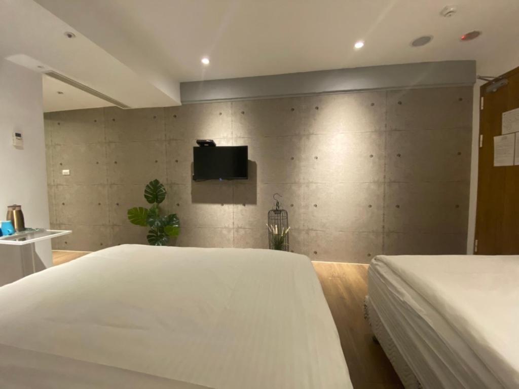 Postel nebo postele na pokoji v ubytování M Taipei Hotel