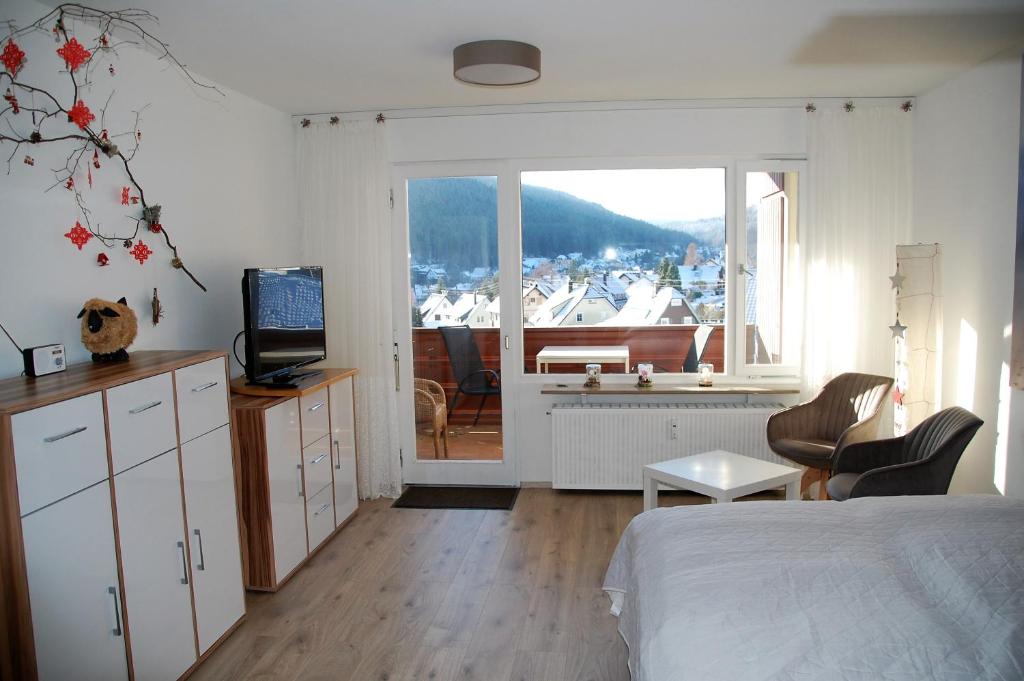 a bedroom with a bed and a view of a boat at Ferienwohnung mit Aussicht in Enzklösterle