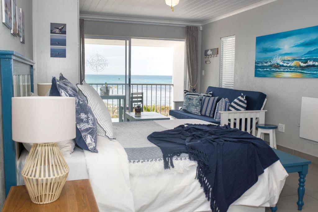 a bedroom with a bed and a view of the ocean at True North West Coast in St Helena Bay