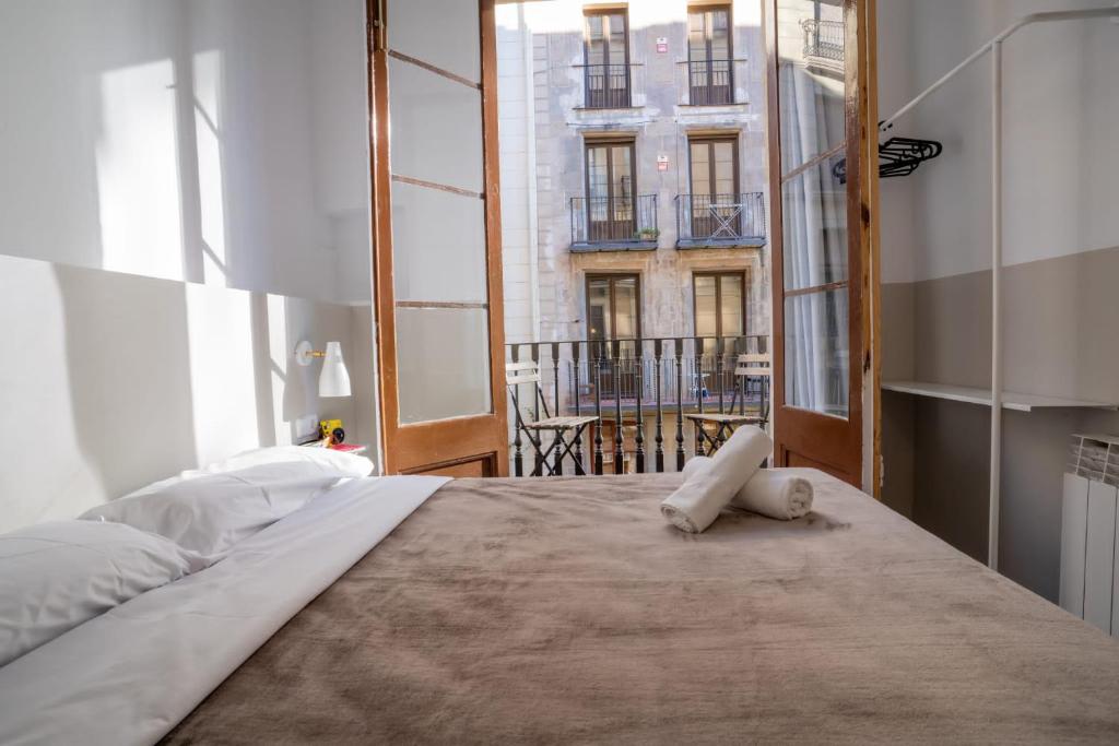 a bedroom with a large bed with a large window at Hostal Hera in Barcelona
