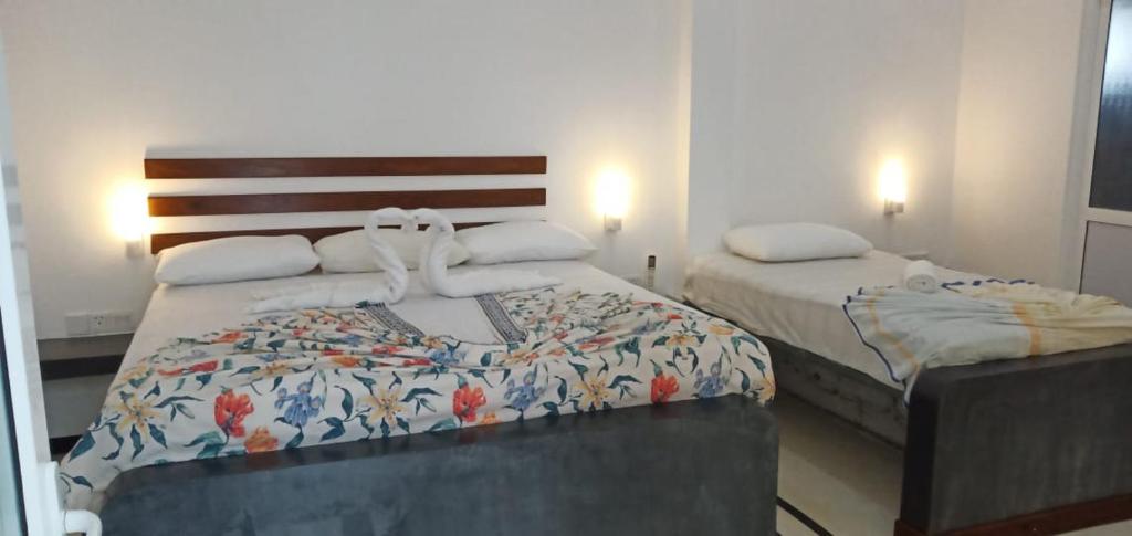 Postel nebo postele na pokoji v ubytování Petit Guest House