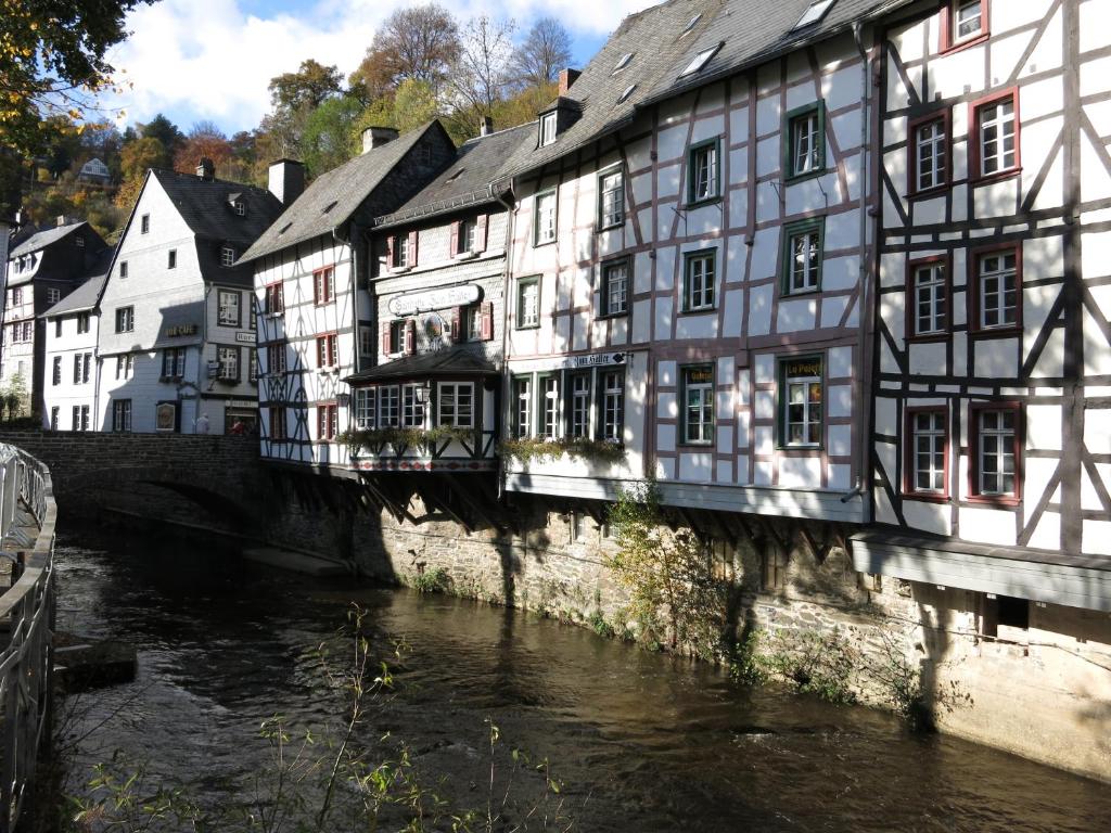 a group of buildings next to a river in a town at Historisches Haus im Herzen von Monschau in Monschau