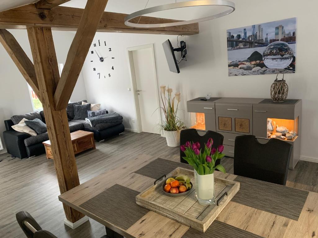 a living room with a table and a fireplace at FEWO Hoppegarten in Hoppegarten