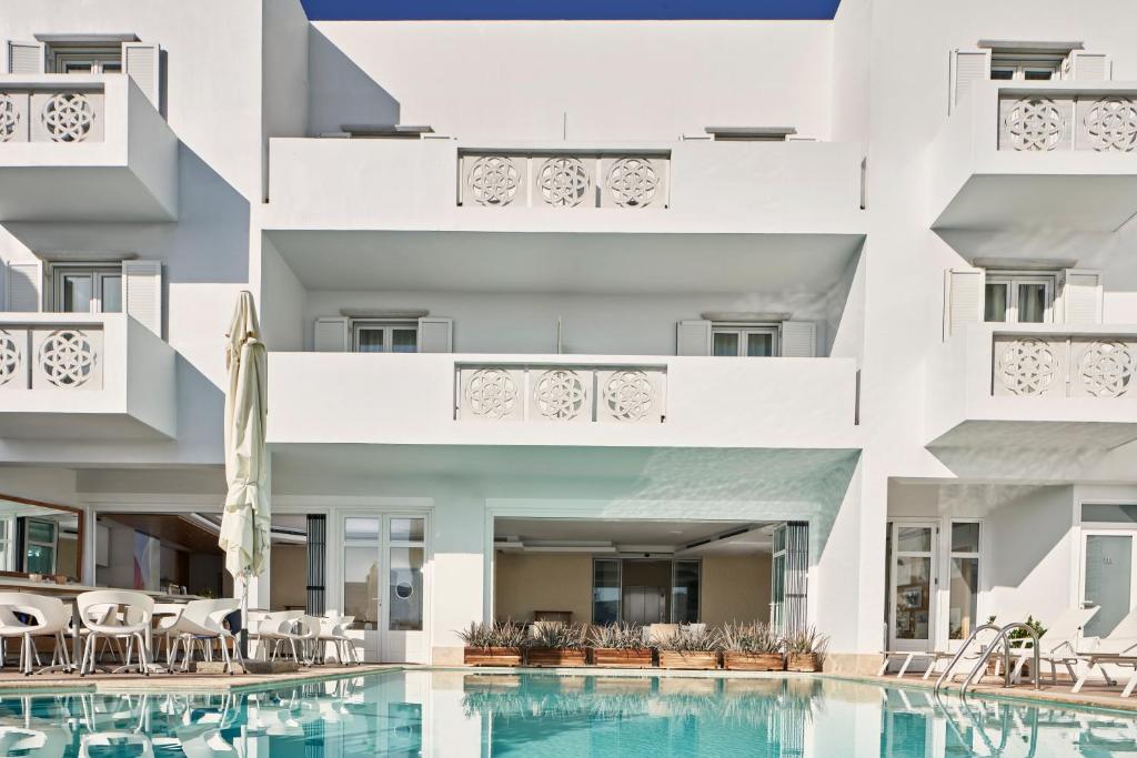 an external view of a building with a pool at Oxygen Favie in Tinos Town