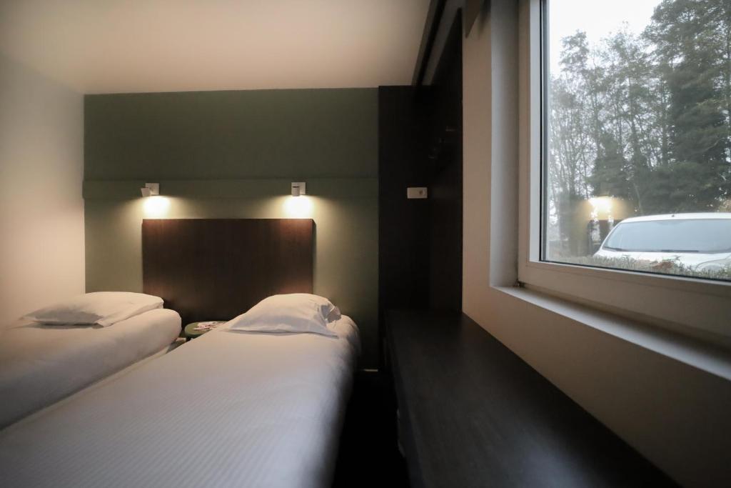 Postel nebo postele na pokoji v ubytování Travel Hotel Kruisem