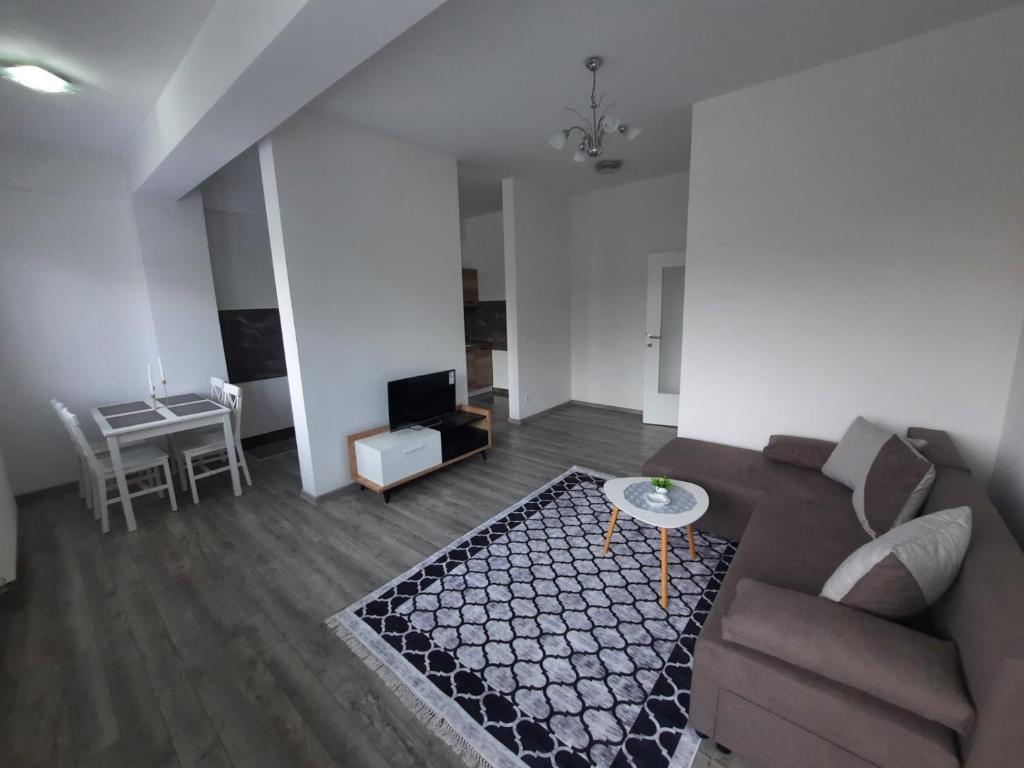 a living room with a couch and a table at Apartman San in Bugojno