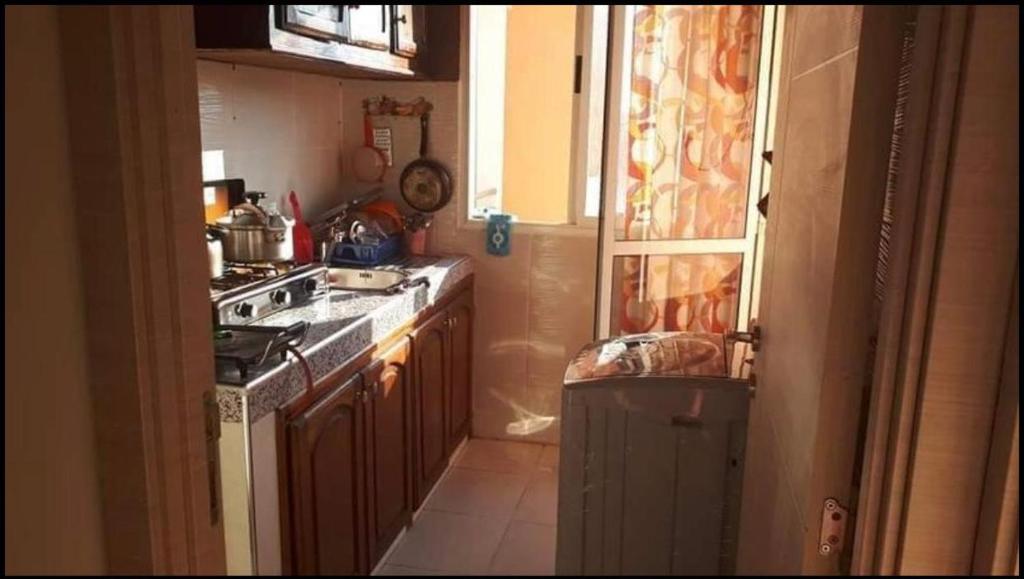 A kitchen or kitchenette at Appartement a louer calme