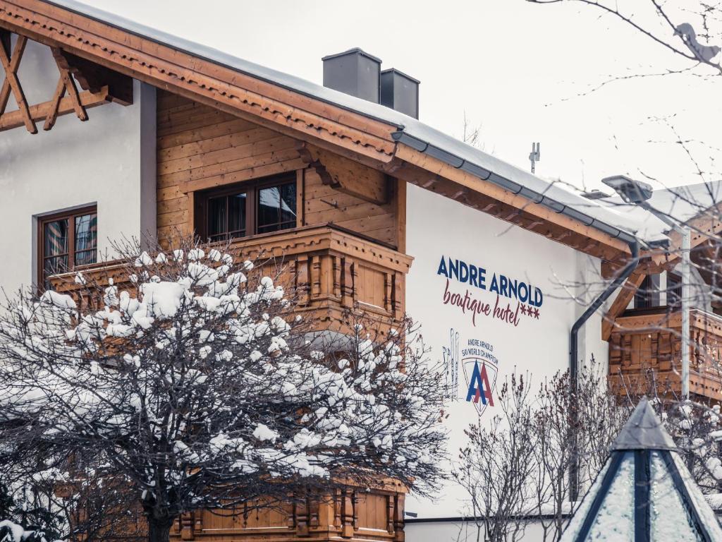 a log building with a sign on the side of it at Andre Arnold - Boutique Pension in Sölden