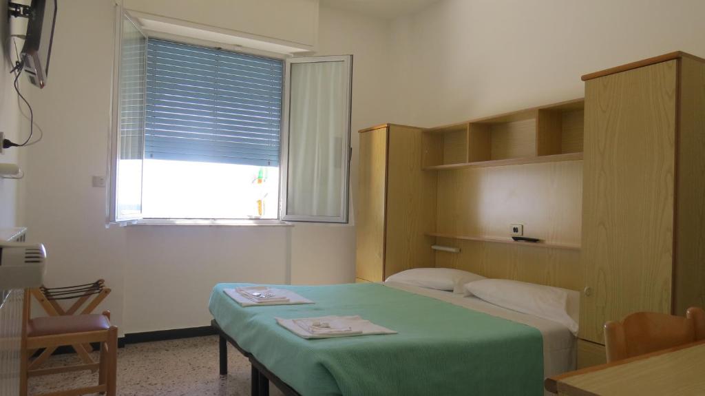 Posteľ alebo postele v izbe v ubytovaní Albergo Anita