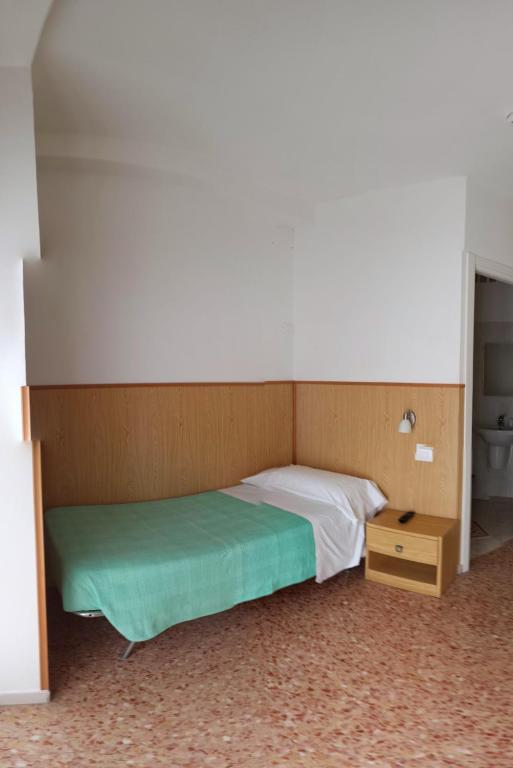 Posteľ alebo postele v izbe v ubytovaní Albergo Anita