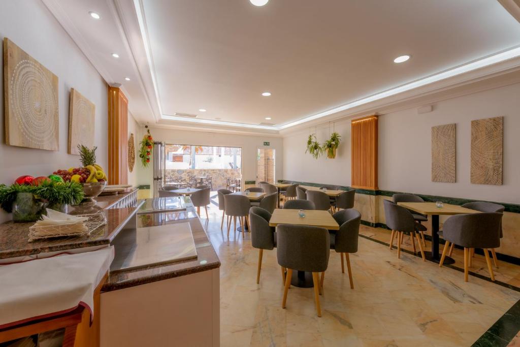 a restaurant with tables and chairs in a room at Hotel Boutique Sibarys - Adults Recommended in Nerja