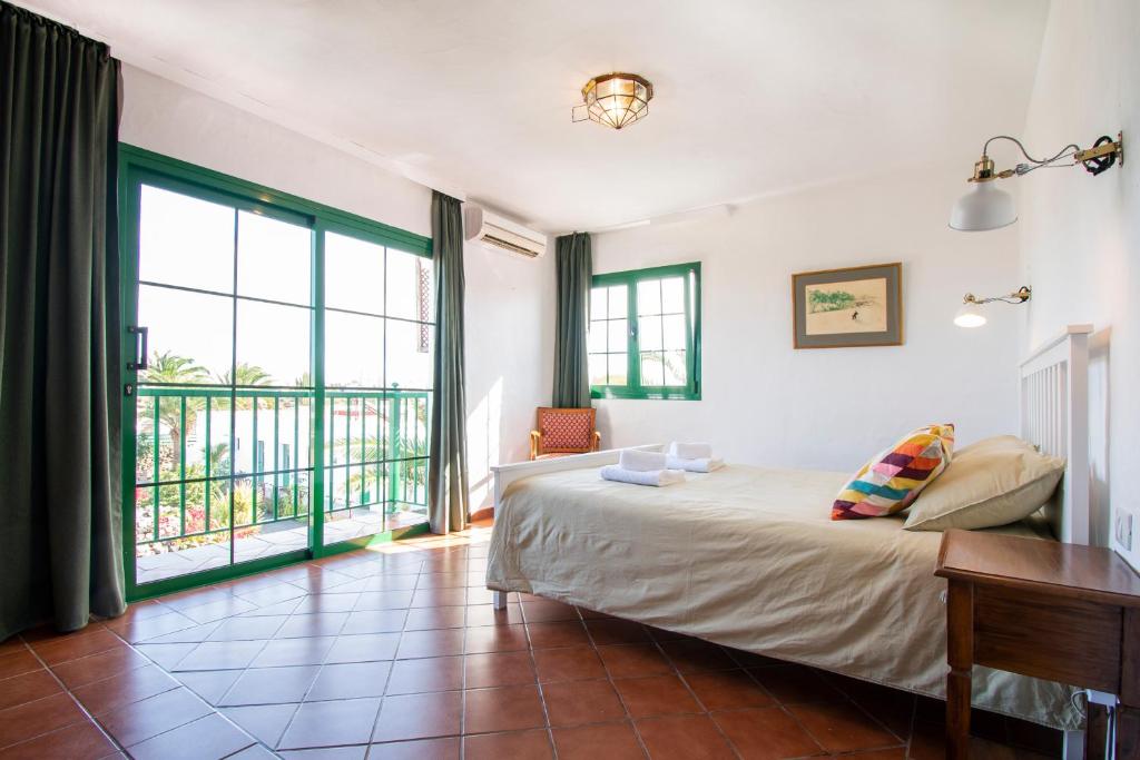 a bedroom with a bed and a large window at Surfescape Fuerteventura in Lajares
