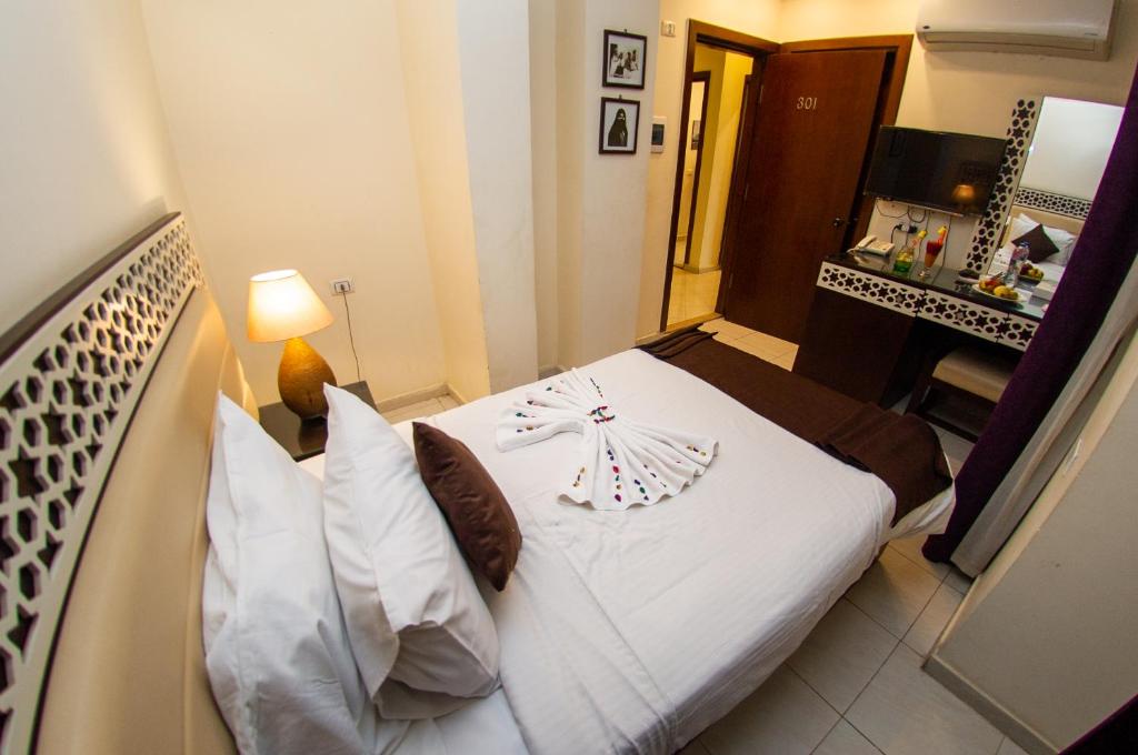Postel nebo postele na pokoji v ubytování Pyramids Valley Boutique Hotel
