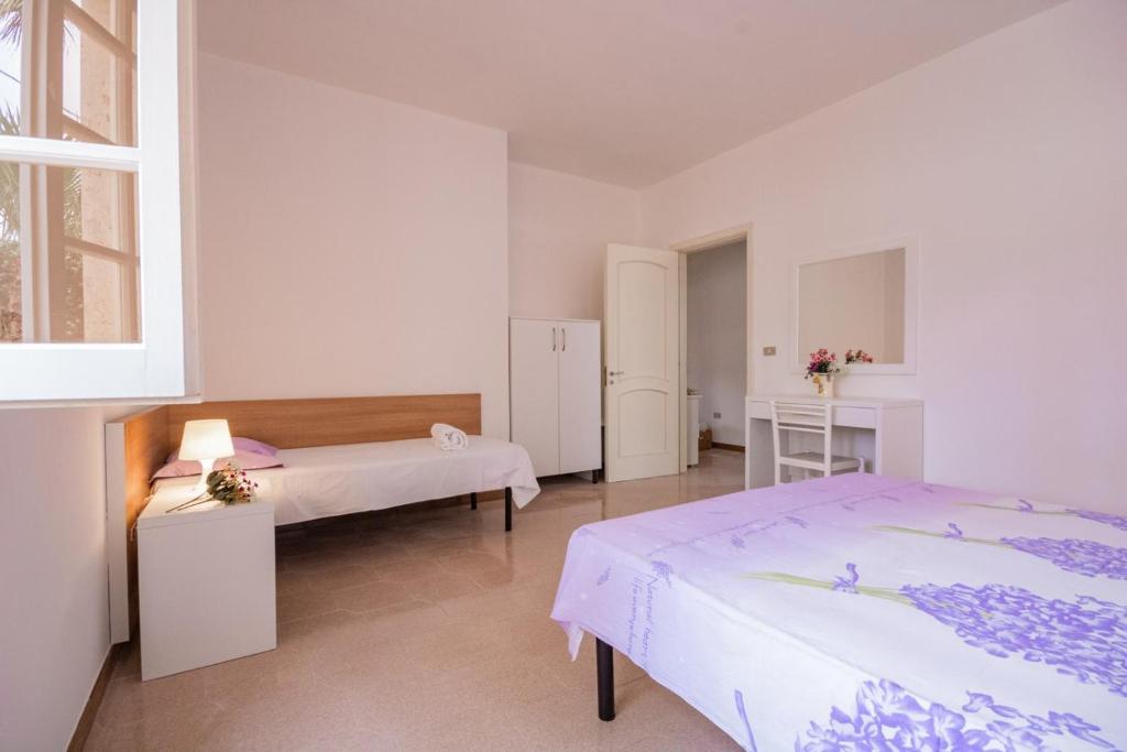 Łóżko lub łóżka w pokoju w obiekcie VILLA ISCHIA