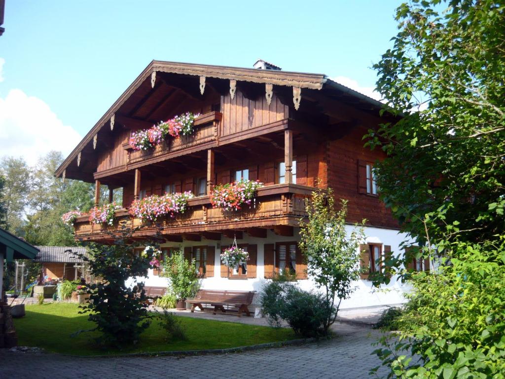 a large wooden house with flower boxes on it at Gästehaus Kress - Chiemgau Karte in Inzell