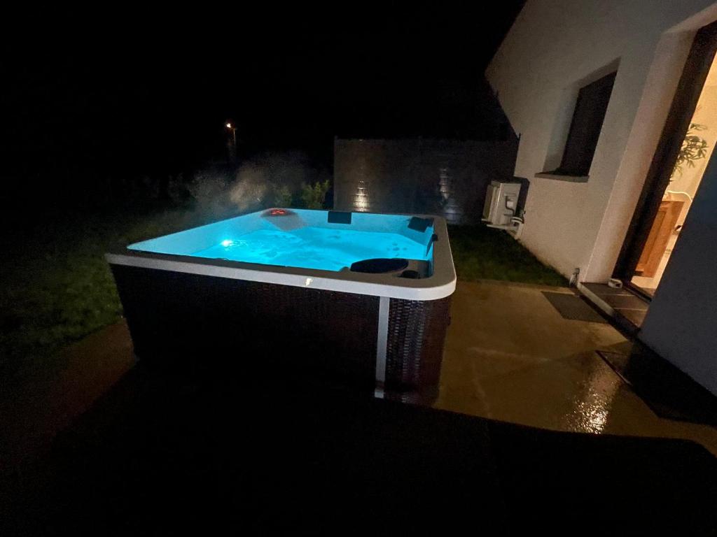 a hot tub in a yard at night at Le Paradis du petit Rupembert in Wimille
