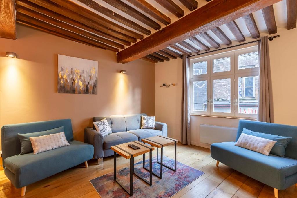 a living room with two blue couches and a table at La Cachette de Lucie - center of Honfleur - 100m from the Port - 2P in Honfleur