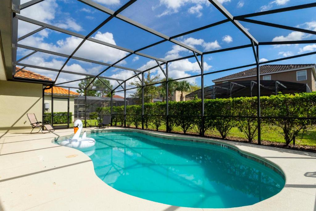 a swimming pool in a house with a glass roof at Gorgeous 4Bd Close to Disney w/ Pool @ 4072 Solterra Resort in Davenport