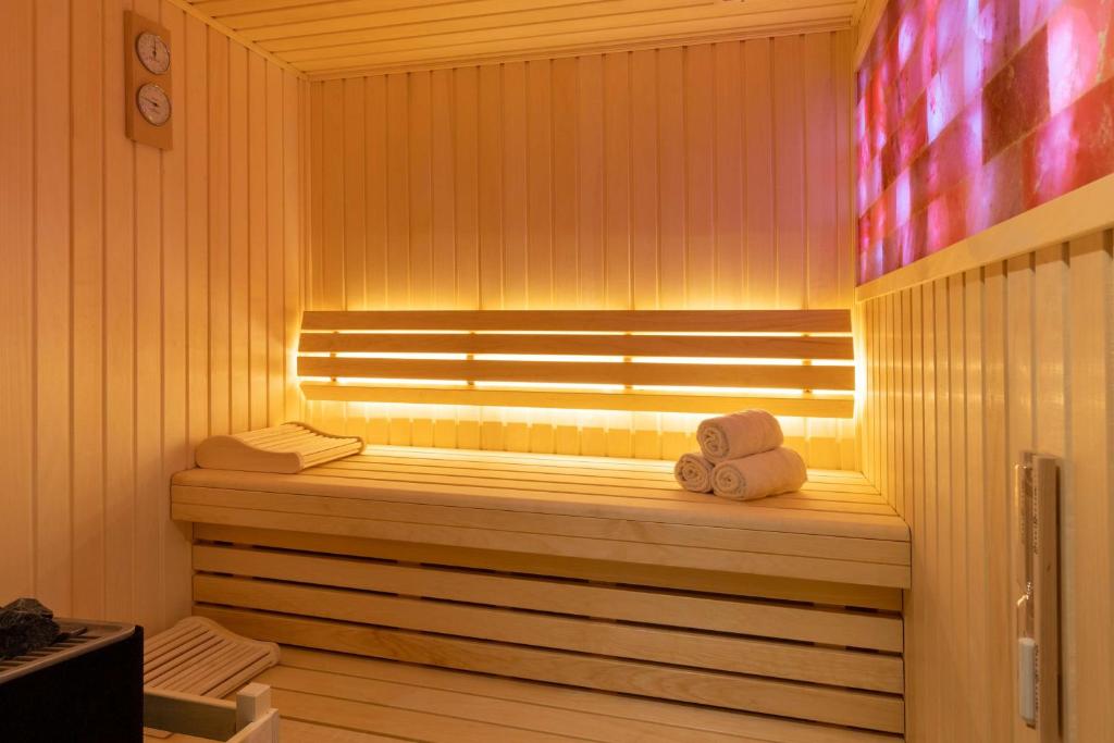 a sauna with two teddy bears sitting on a bench at Best Western Plus Le Conquerant Rouen Nord in Bois-Guillaume